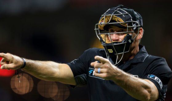 MLB umpire Angel Hernandez signals during a baseball game between the Arizona Diamondbacks and the Cincinnati Reds in Cincinnati, Ohio, on June 8, 2022.