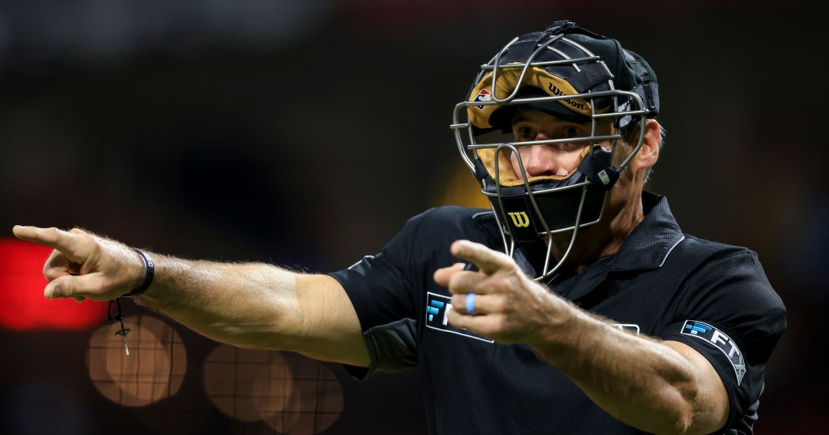 MLB umpire Angel Hernandez signals during a baseball game between the Arizona Diamondbacks and the Cincinnati Reds in Cincinnati, Ohio, on June 8, 2022.