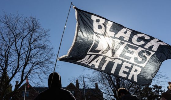 A man holds a Black Lives Matter flag" in St.Paul, Minnesota, in a file photo from March 6, 2021.