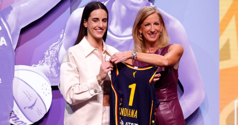 Caitlin Clark posing with WNBA Commissioner Cathy Engelbert after being drafted first by the Indiana Fever at the 2024 WNBA Draft in New York City.