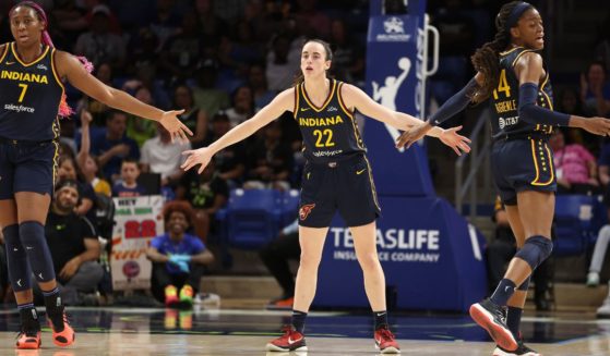 Caitlin Clark (#22) of the Indiana Fever celebrates a first-half three-pointer with Allya Boston (#7) and Tami Fagbenle (#14) while playing the Dallas Wings at College Park Center Friday in Arlington, Texas.