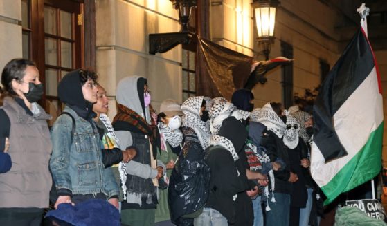 Anti-Israel protesters lock arms at the entrance to Hamilton Hall on the campus of Columbia University in New York City on Tuesday.