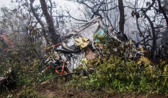 Wreckage is seen at the crash site of a helicopter transporting Iranian President Ebrahim Raisi and others in a fog-covered mountainous area of Varzaghan in northwestern Iran on Monday.