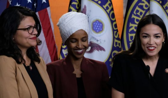 Reps. Rashida Tlaib, left; Ilhan Omar, center; and Alexandria Ocasio-Cortez, right, listen during a news conference at the U.S. Capitol in Washington, D.C., on July 15, 2019.