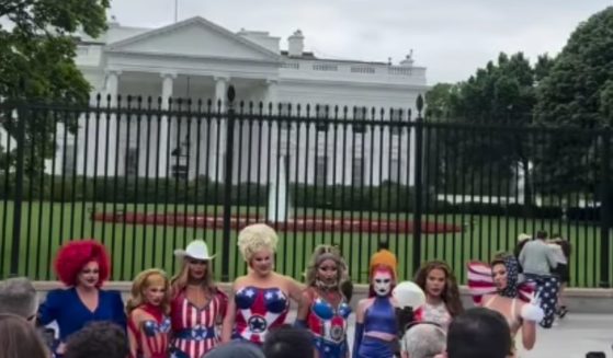 A group of eight drag queens from "Ru Paul's Drag Race All Stars" pose outside the White House in Washington, D.C., on Monday.