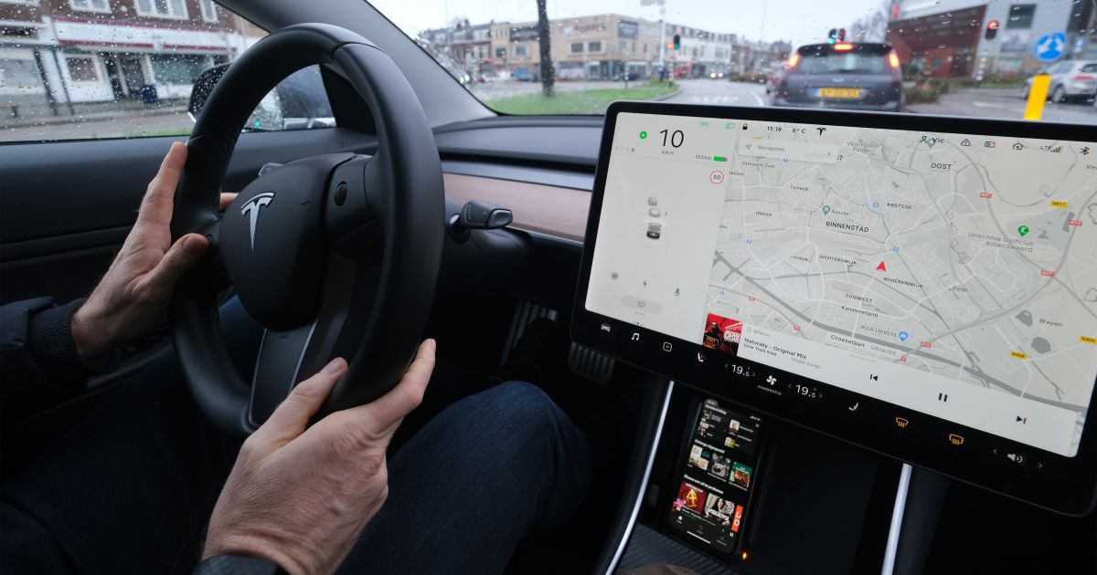 A man drives his Tesla Model 3 in Utrecht, The Netherlands, on Dec. 27, 2020.