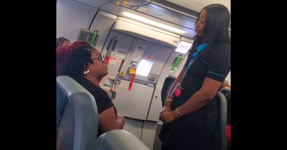 A passenger argues with a flight attendant on a Frontier Airlines flight.