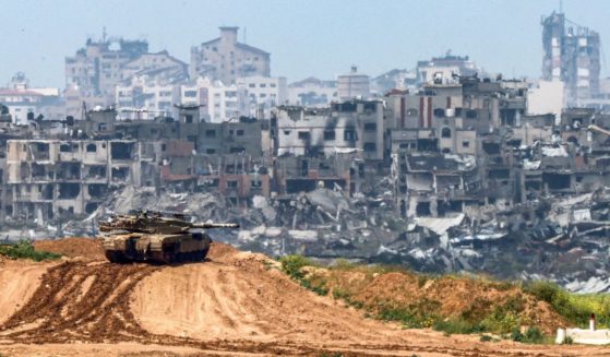 A photo taken from Israel's southern border with the Gaza Strip shows an Israeli tank at a position along the border with the Palestinian territory on March 19.