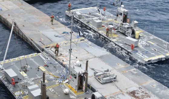 Soldiers assigned to the 7th Transportation Brigade and sailors attached to the MV Roy P. Benavidez assemble the Roll-On, Roll-Off Distribution Facility. or floating pier, off the shore of Gaza in the Mediterranean Sea on April 26.