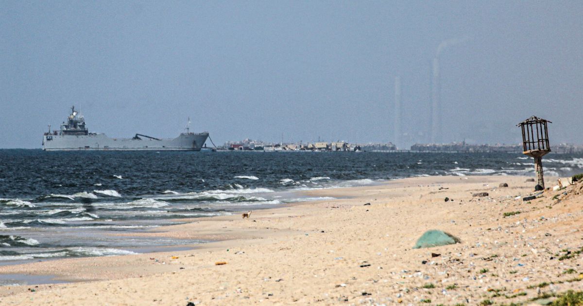 A ship transporting international humanitarian aid is moored at the U.S.-built floating pier near Nuseirat in the Gaza Strip on Tuesday.