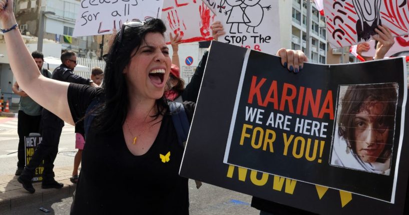 A woman holds a placard bearing the image of 19-year-old Israeli hostage Karina Ariev in front of the Branch Office of the U.S. embassy in Tel Aviv, Israel, in a file photo from March 1.