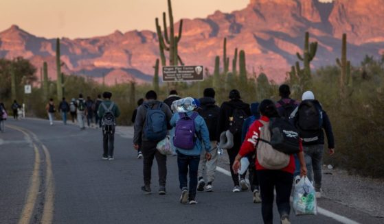 Illegal immigrants walk into the United States after crossing from Mexico to Lukeville, Arizona, on Dec. 7.