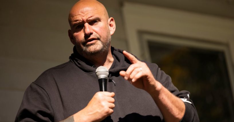 Sen. John Fetterman peaks at a campaign event held for Pennsylvania judicial candidates at Snipes Farm in Morrisville, Pennsylvania, on Oct. 28.