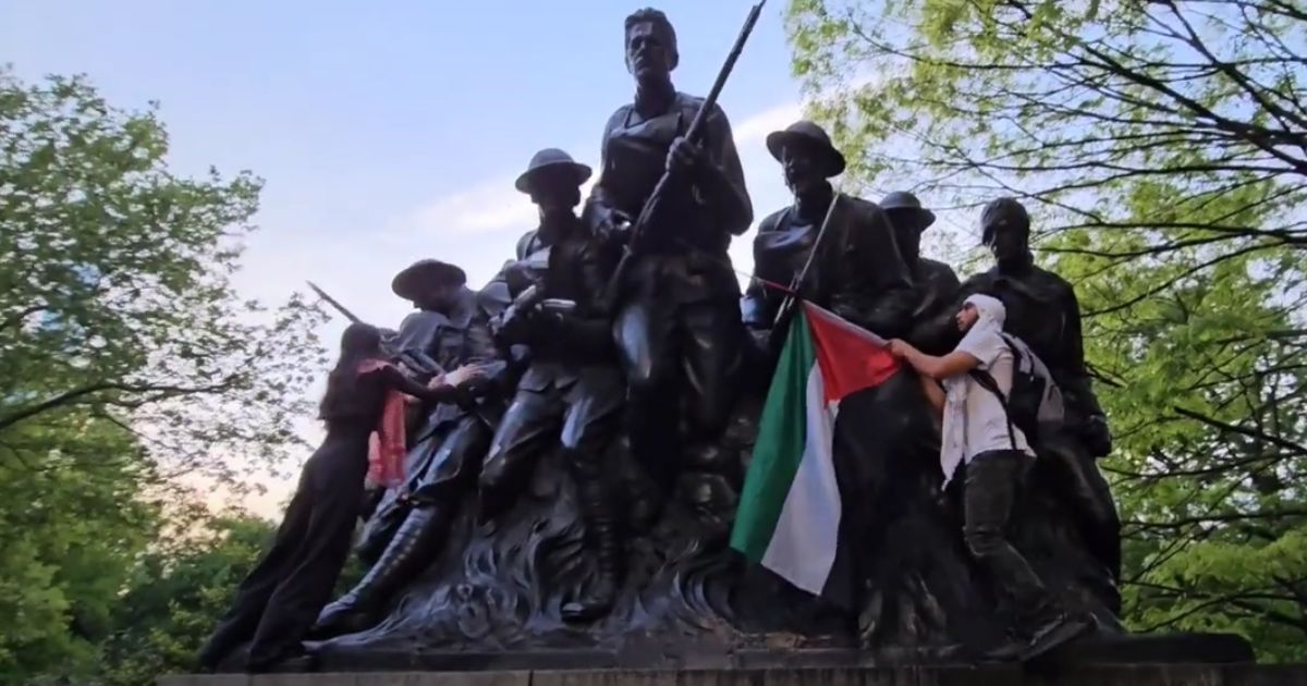 Anti-Israel protesters deface the 107th Infantry Memorial in New York's Central Park on Monday.