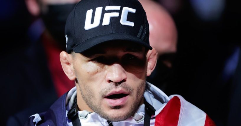 Michael Chandler walks to the Octagon draped in an American flag prior to facing Charles Oliveira of Brazil for their Championship Lightweight Bout at the UFC 262 in Houston, Texas, on May 15, 2021.