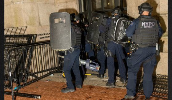 Members of the NYPD surround and breach Hamilton Hall where demonstrators barricaded themselves inside on the Columbia University campus Tuesday in New York City. Police arrested nearly 100 people as they cleared the university of demonstrators who were issued a notice to disband their encampment after negotiations failed to come to a resolution. Now Columbia Law Review students are demanding that their final exams be cancelled because of the trauma of having police on their campus.