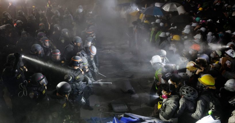 California State Police officers face off with anti-Israel demonstrators after destroying part of the encampment barricade on the campus of the UCLA in Los Angeles early Tuesday morning.