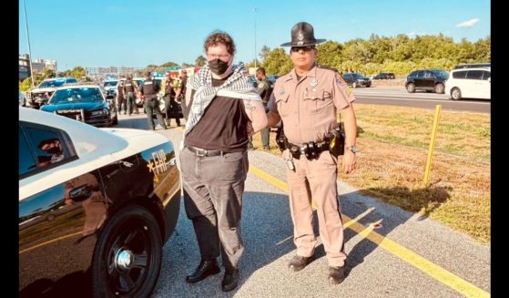 Queers for Palestine protesters who blocked Interstate 4 in Orlando, Florida, are arrested by the Florida Highway Patrol.