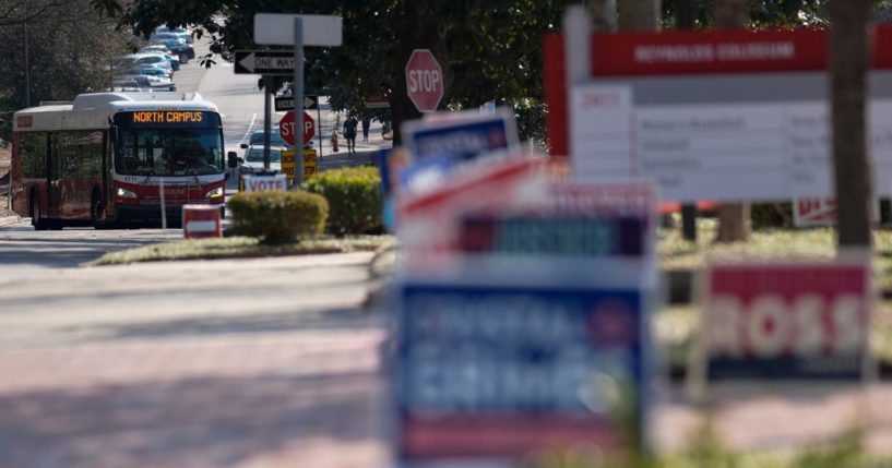 A bus moves near election signs at an election center on the campus of North Carolina State University in Raleigh on Feb. 22.