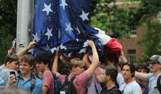 On Tuesday, a group of UNC student, identified as members of fraternities, stood together to hold up the American flag for an hour while anti-Israel protesters attempting to take down the flag and threw bottles, water, and rocks at them and hurled insults.