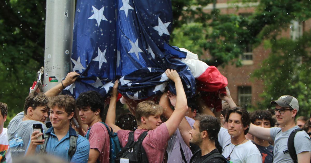 On Tuesday, a group of UNC student, identified as members of fraternities, stood together to hold up the American flag for an hour while anti-Israel protesters attempting to take down the flag and threw bottles, water, and rocks at them and hurled insults.