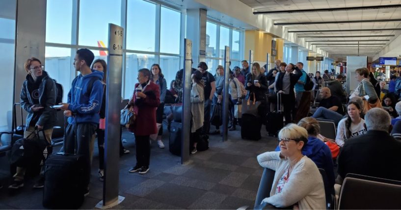 People line up based on boarding group numbers to board a Southwest Airlines flight at Oakland International Airport in California on Jan. 5, 2020.