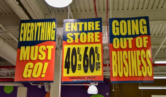 A stock photo shows signs in a store that's going out of business.