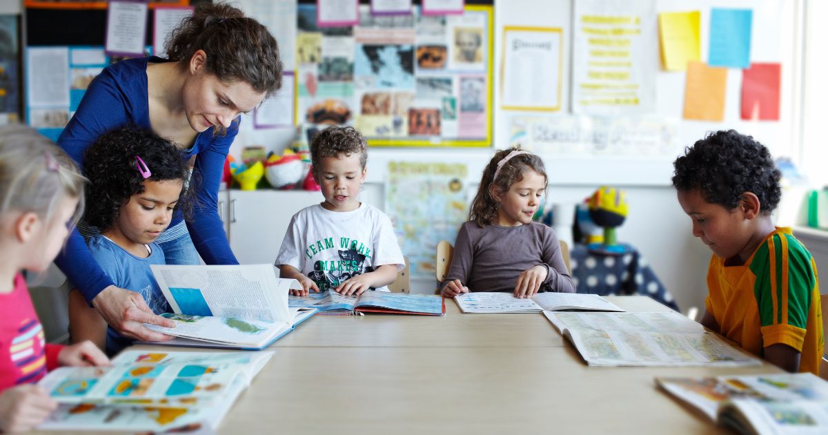 This stock image shows students reading in a classroom.