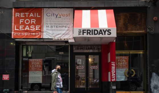 A man walks past a For Lease sign at a closed down TGI Fridays in New York City on Oct. 22, 2020.