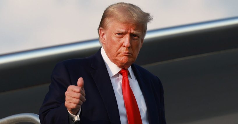 Former President Donald Trump gives a thumbs up as he arrives at Atlanta Hartsfield-Jackson International Airport in Atlanta on Aug. 24.