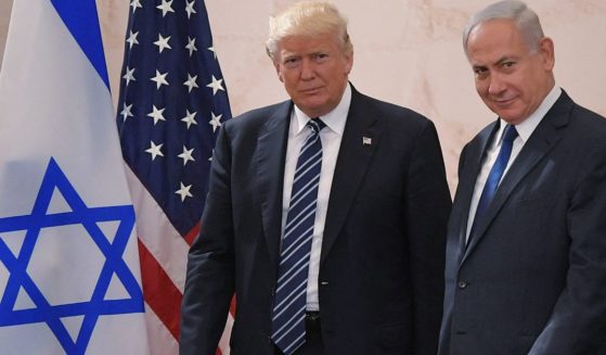 President Donald Trump walks alongside Israel's Prime Minister Benjamin Netanyahu as he arrives to deliver a speech at the Israel Museum in Jerusalem on May 23, 2017.