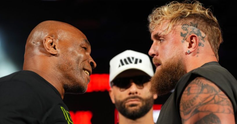 Mike Tyson, left, and Jake Paul pose onstage during a news conference at Texas Live! in Arlington, Texas, on May 16.