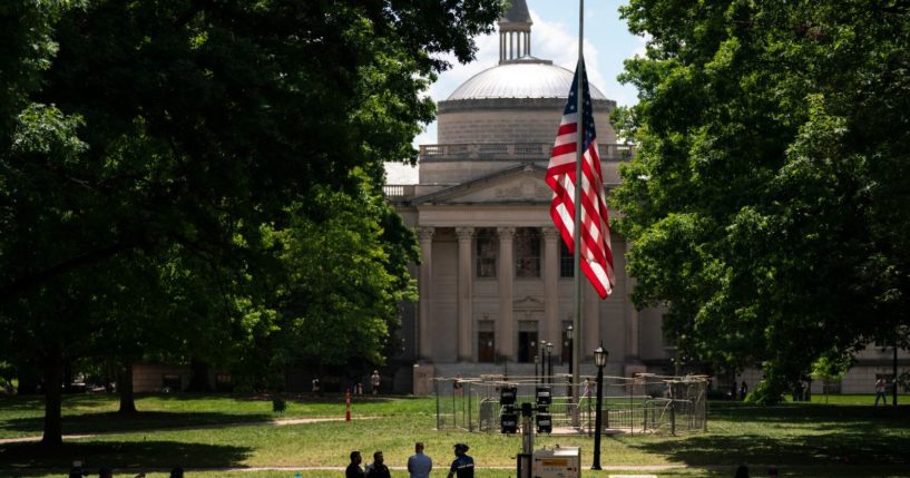 A barricade protects the American flag at Polk Place at the University of North Carolina on Wednesday in Chapel Hill, North Carolina. On Tuesday, protesters removed an American flag and raised a Palestinian flag following a dispersed encampment at Polk Place on the campus of the University of North Carolina.