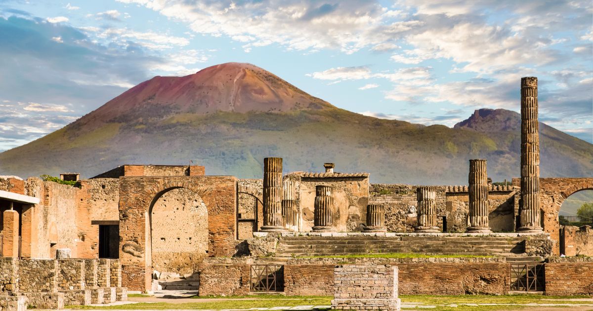 Ancient walls in Pompeii, with Mount Vesuvius in the background.