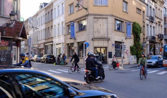 People cross at the intersection between the 'Rue du Trone' and the 'Chaussee de Wavre' on March 28, 2024 in Ixelles, Belgium.