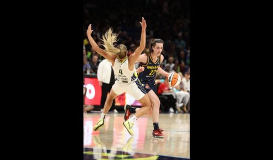 Caitlin Clark #22 of the Indiana Fever drives against Jacy Sheldon #4 of the Dallas Wings at College Park Center on May 3, 2024 in Arlington, Texas.