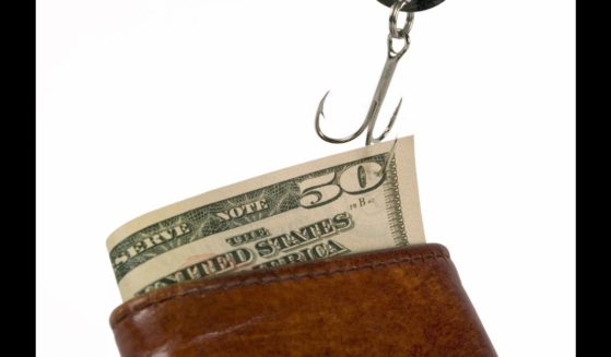 This Getty stock image shows a $50 bill stuck on a fishing hook, being pulled out of a wallet.