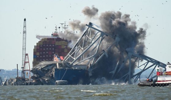 Crews conduct a controlled demolition of a section of the Francis Scott Key Bridge resting on the Dali container ship in Baltimore on Monday.