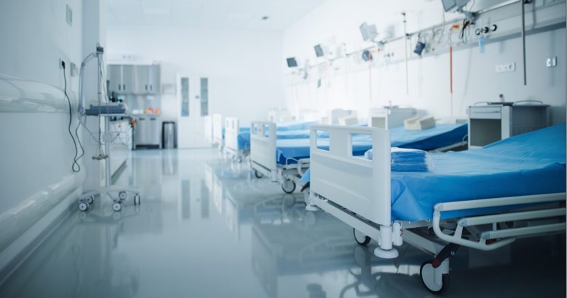 A row of empty hospital beds.