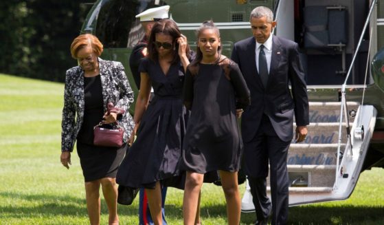 From left, Marian Robinson, first lady Michelle Obama, Sasha Obama and then-President Barack Obama exit Marine One and walk toward the residence of the White House on June 6, 2015, in Washington, D.C.