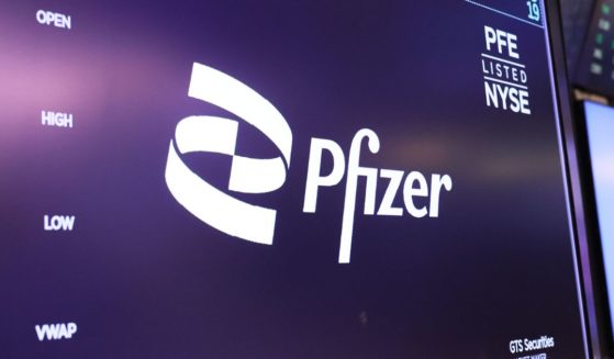 The Pfizer company logo is displayed as traders work on the floor of the New York Stock Exchange during morning trading on April 10, 2023 in New York City.