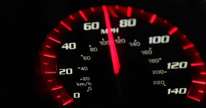 A stock photo shows a speedometer shows a car going about 70 mph.