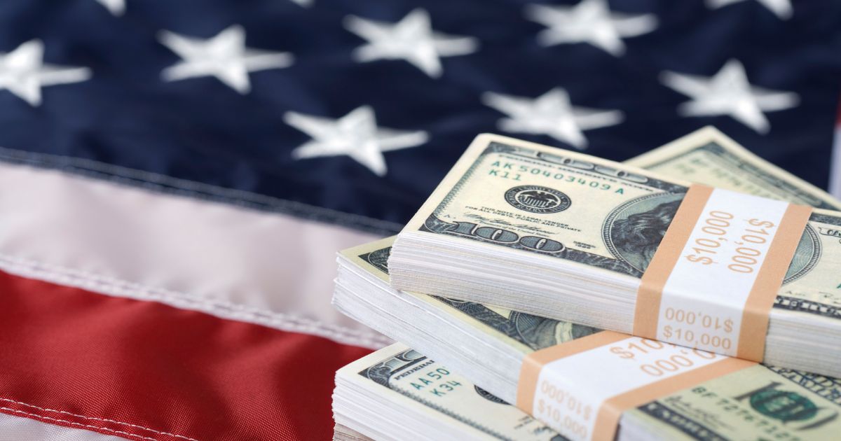 This Getty stock image shows a stack of cash on the U.S. flag.