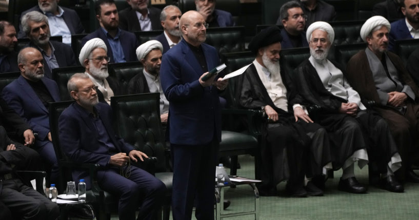 Mohammad Bagher Qalibaf, center, takes an oath during the opening ceremony of the new parliament term in Tehran, Iran, on May 27.