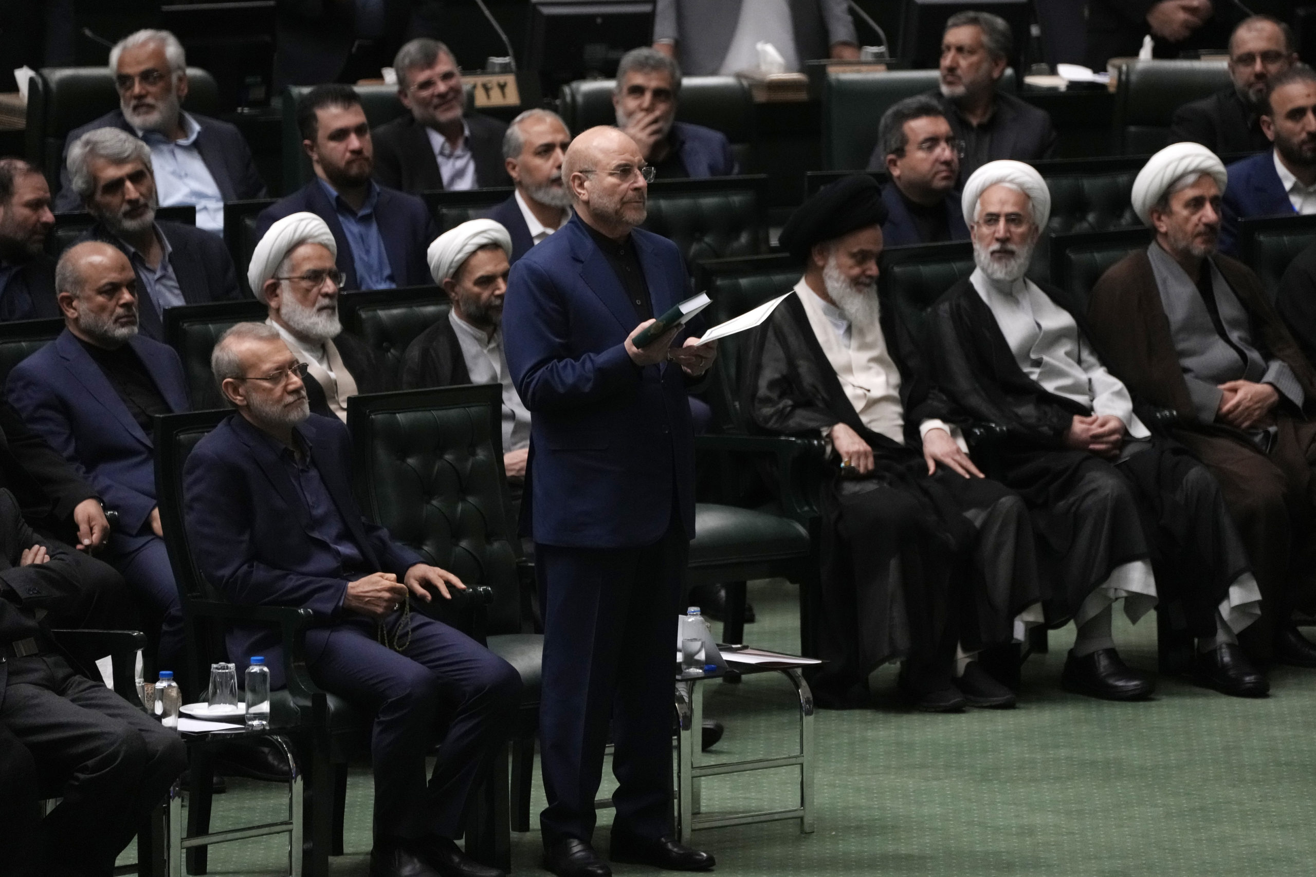 Mohammad Bagher Qalibaf, center, takes an oath during the opening ceremony of the new parliament term in Tehran, Iran, on May 27.