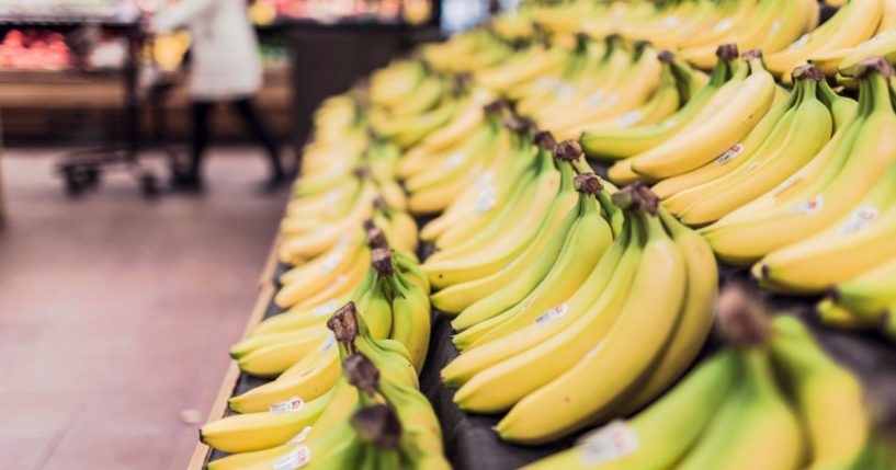 This image shows many bananas on display at a grocery store.