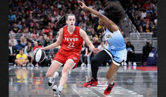 Caitlin Clark #22 of the Indiana Fever dribbles against Dana Evans #11 of the Chicago Sky during the first quarter in the game at Gainbridge Fieldhouse Saturday in Indianapolis, Indiana.