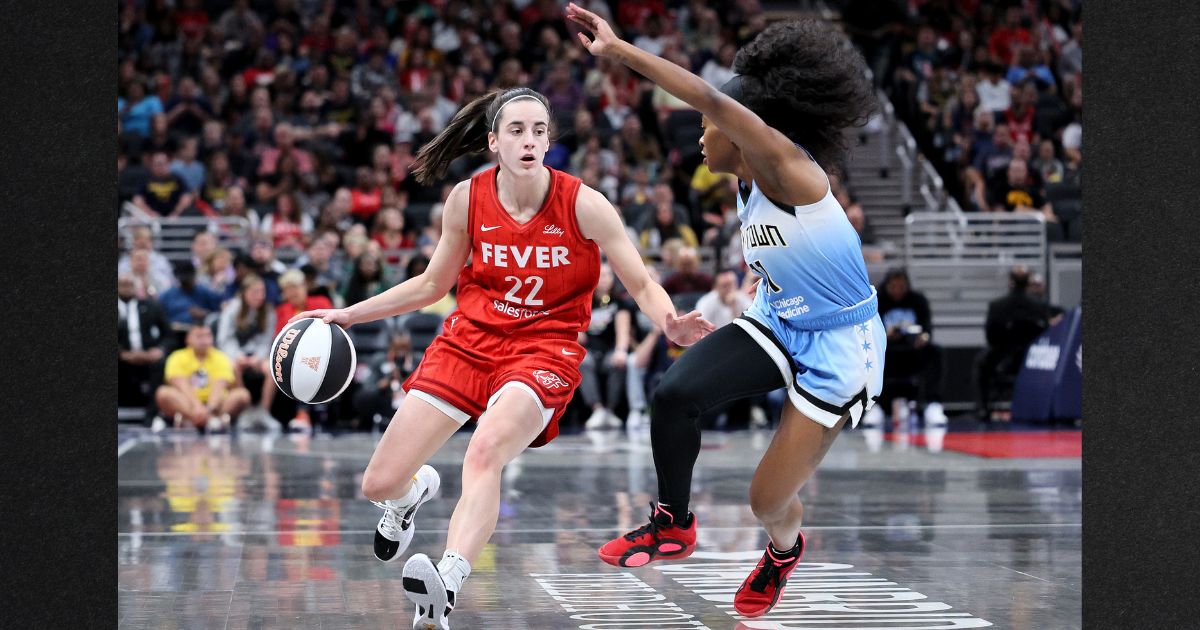 Caitlin Clark #22 of the Indiana Fever dribbles against Dana Evans #11 of the Chicago Sky during the first quarter in the game at Gainbridge Fieldhouse Saturday in Indianapolis, Indiana.