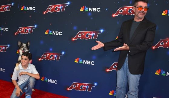 Simon Cowell gestures to his son, Eric Philip Cowell, at the "America's Got Talent" Season 18 finale in Pasadena, California, on Sept. 27, 2023.
