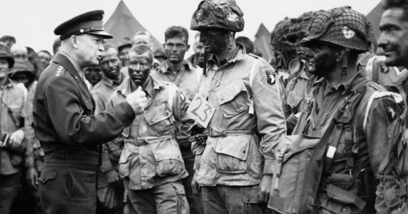 Allied Commander in Chief Gen. Dwight D. Eisenhower, left, speaks with American paratroopers at an undisclosed location in England, on June 6, 1944, prior to D-Day.